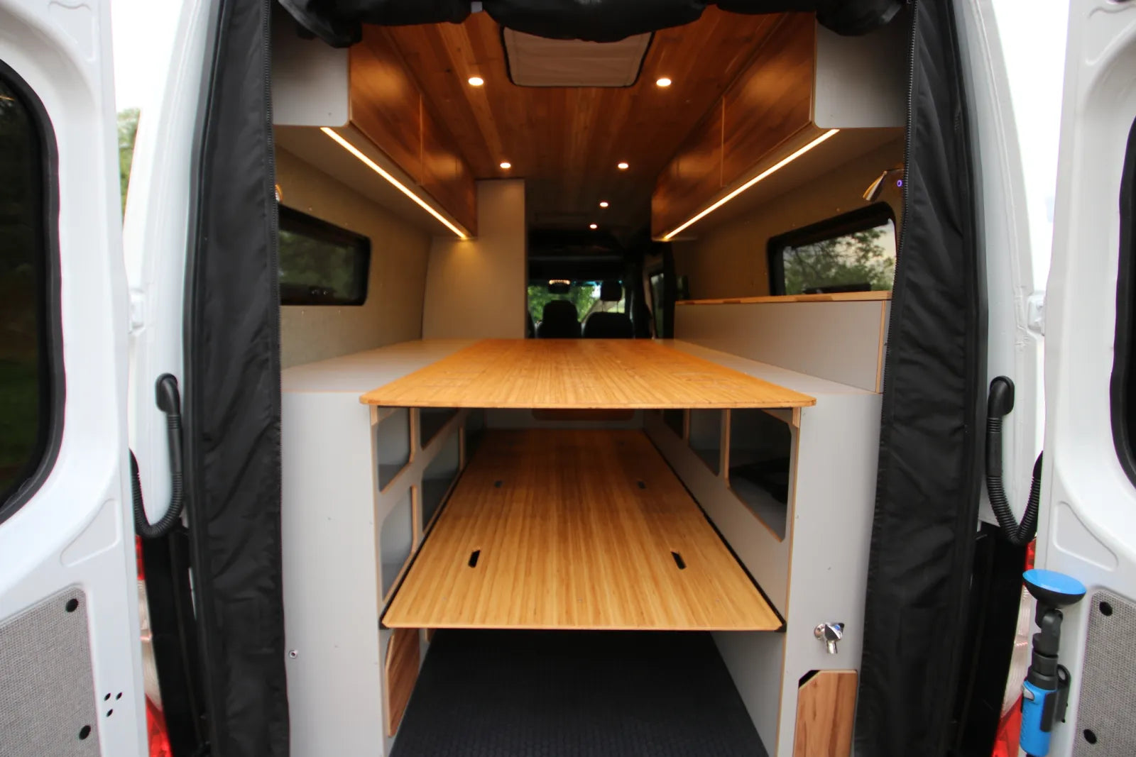 Maverick van conversion rear view with fold-out bed platform and cedar ceiling by The Vansmith