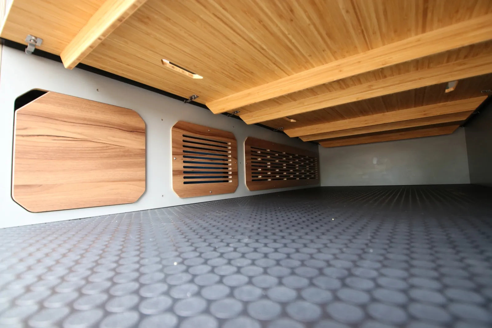Maverick van conversion ventilated under-bed storage compartments with walnut panels by The Vansmith