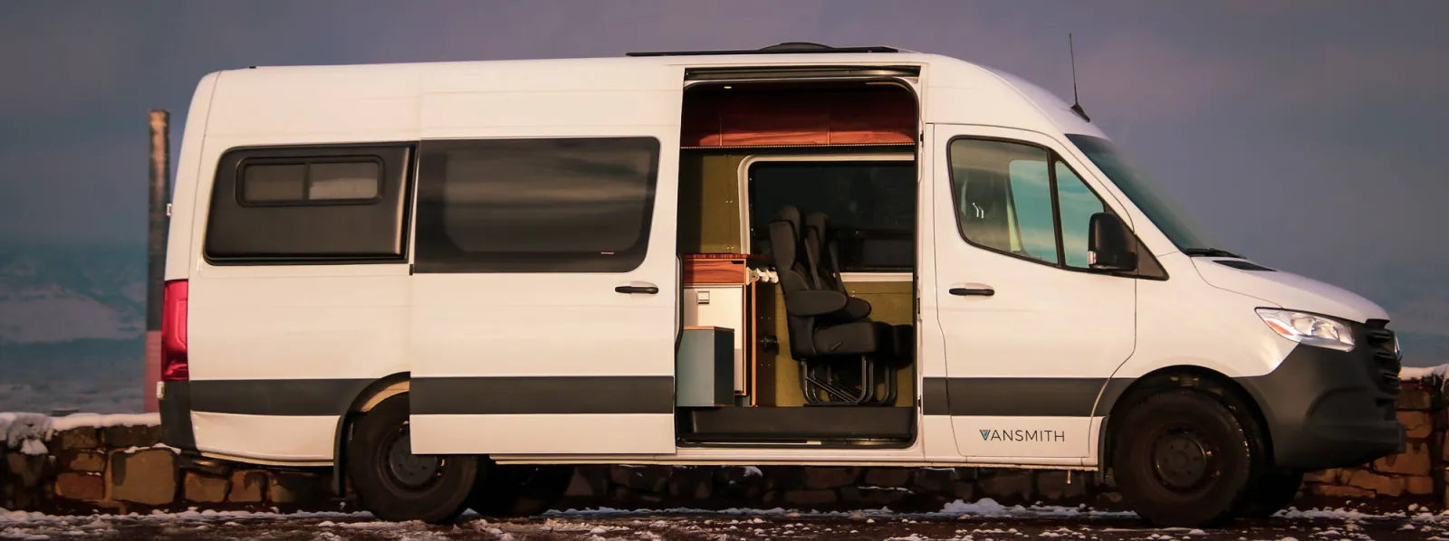 Outpost Crew Sprinter 170 white van conversion with side door open showing seating by The Vansmith