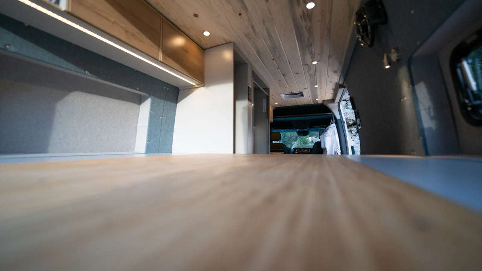Outpost van interior bamboo countertop with cedar plank ceiling and LED accents