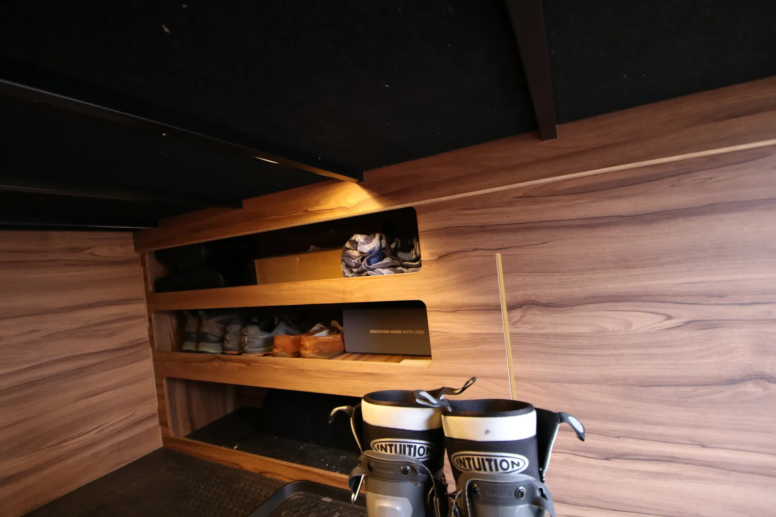 Rapp van walnut shoe and gear shelving in under-bed storage area