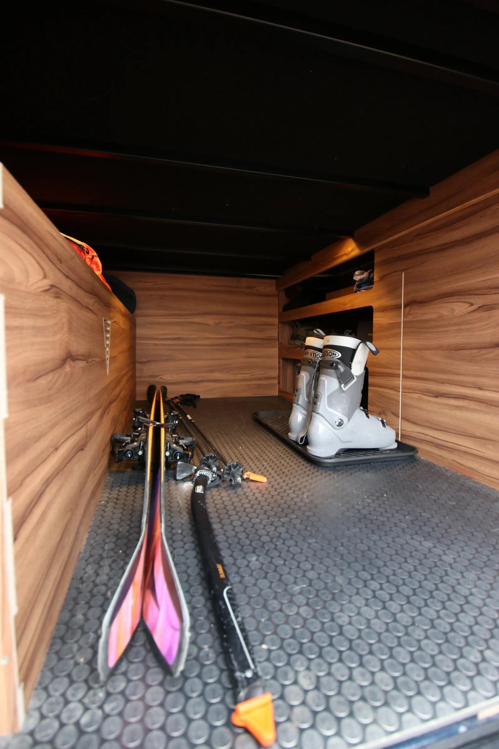 Rapp van under-bed garage with ski equipment and walnut storage shelves