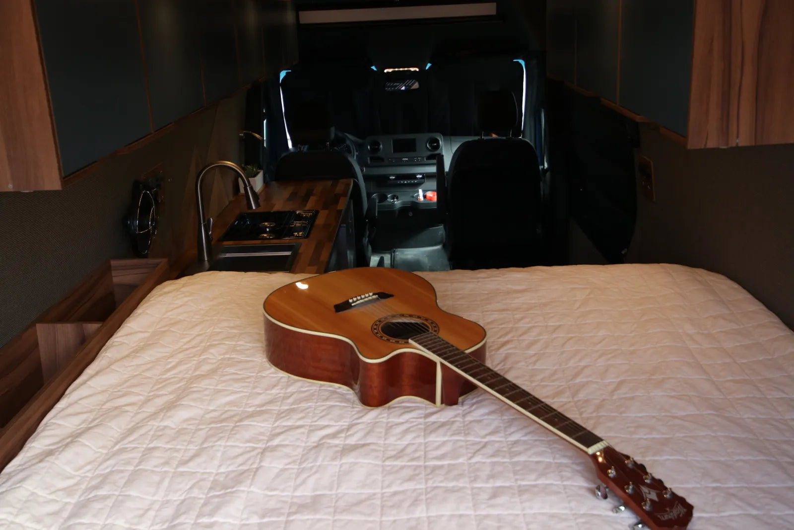 Rapp van queen bed with guitar and walnut platform looking forward to cab