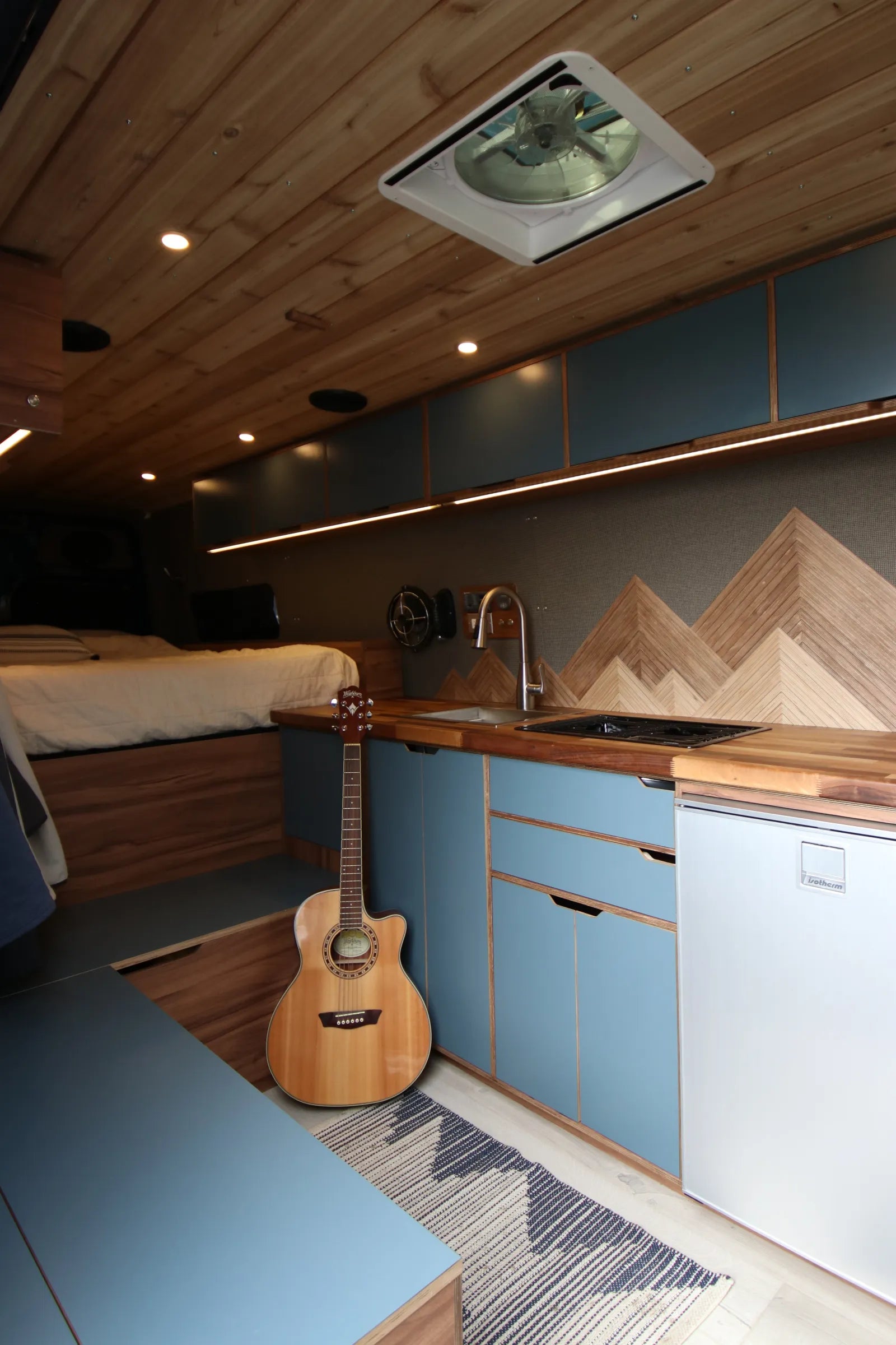 Rapp van blue cabinets with guitar, kitchen galley, and cedar ceiling