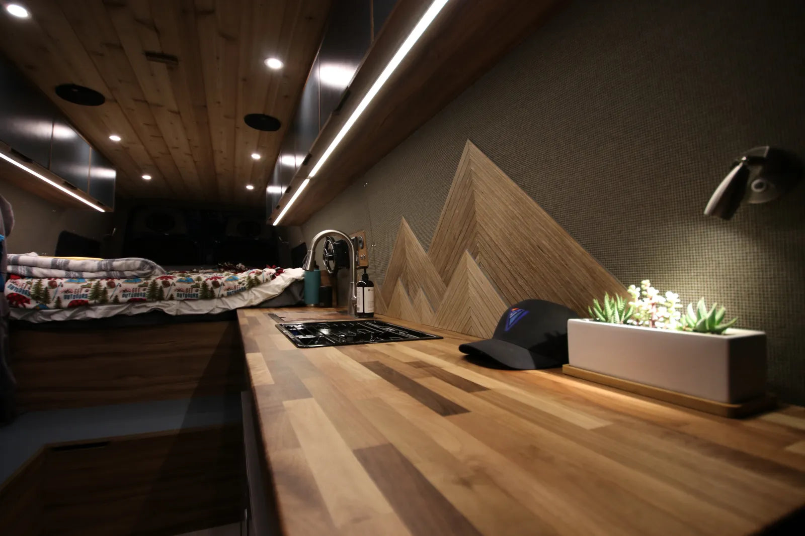 Rapp van butcher block countertop with cooktop and mountain backsplash art