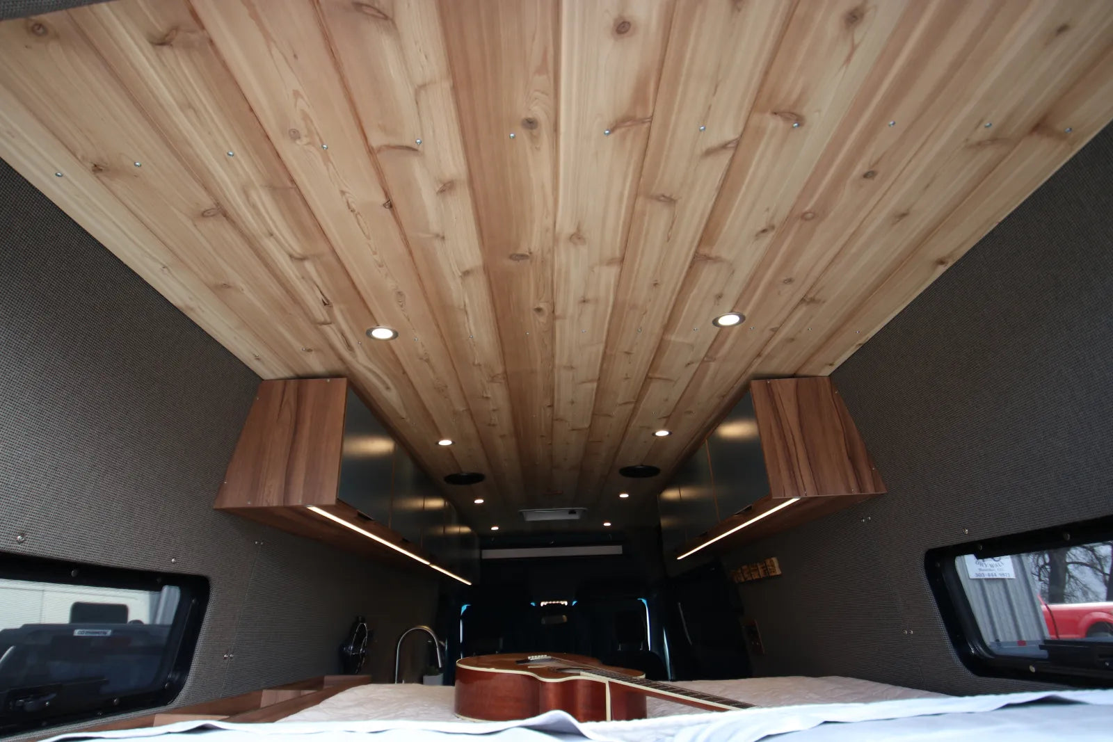 Rapp van cedar plank ceiling with recessed lights and walnut overhead cabinets
