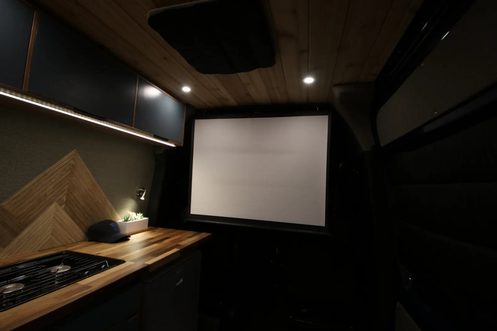 Rapp van built-in projector screen for movie nights in Sprinter conversion