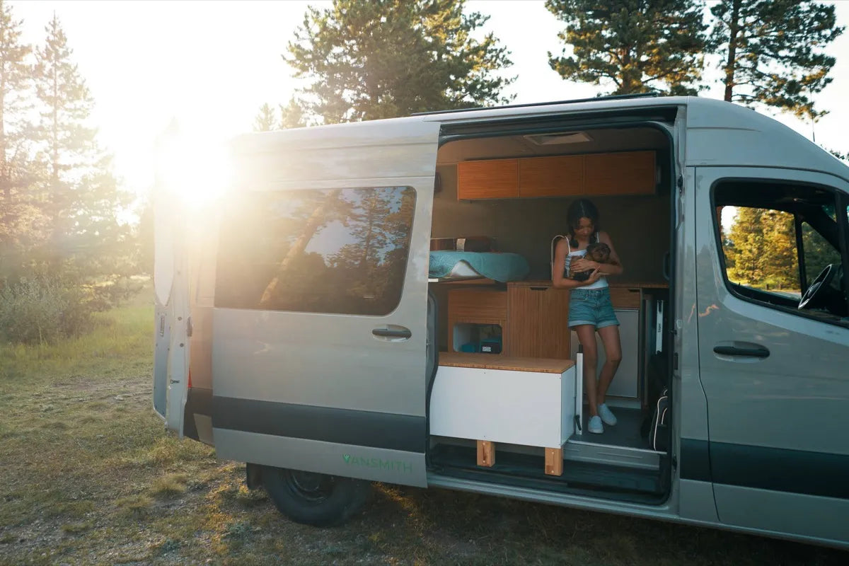Scout Sprinter 144 van at golden hour with sliding door open and person inside near forest by The Vansmith