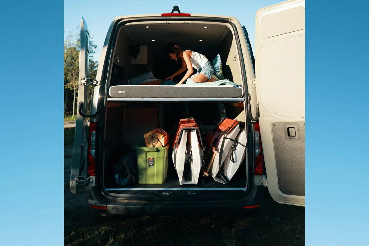 Scout van conversion XL garage storage below floating bed loaded with gear by The Vansmith